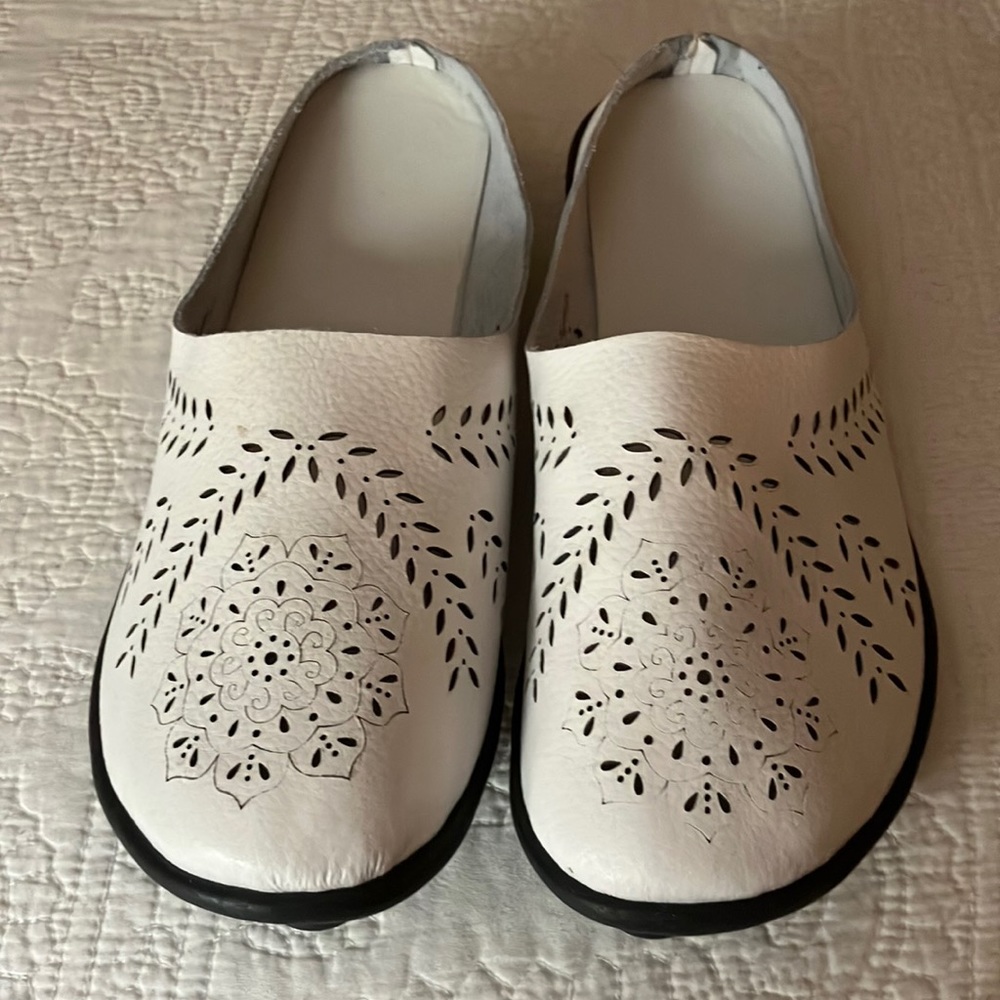 New Clark’s White perforated slip-on sandals.